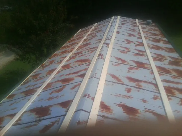 Rusted metal roof panels with new wood purlins before replacement — Storm Damage Roof Repair in Los Gatos by Roofing Brothers